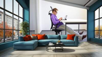 various positions sitting position at the office desk . man on chair working with tablet Wall mural