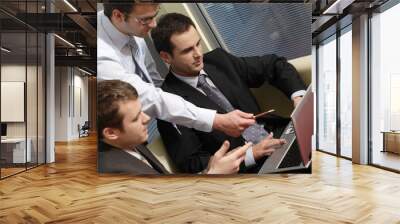 young business men working with latop in office Wall mural