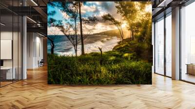 View of the wild south coast of Reunion Island at sunset where the waves break on the basalt rocks - touristic site Wall mural