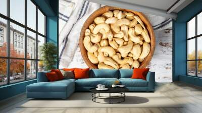 Cashew in wood bowl. Roasted cashews on white wood background. Top view Wall mural