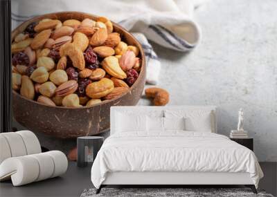 Mixed nuts in bowl on gray background. Nuts, cashews, almonds and pistachios in a coconut bowl. Empty space for text. copy space Wall mural