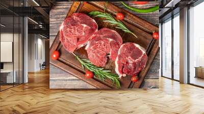 Raw boneless beef shank. Uncooked beef shank meat on a wood serving board. Top view Wall mural