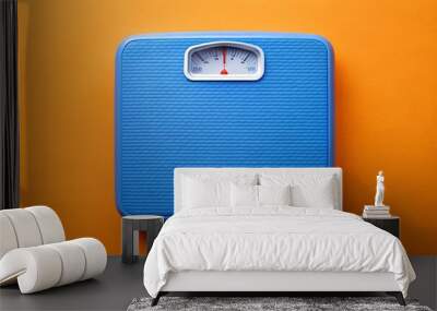 Blue weigh scales on orange background, top view
 Wall mural