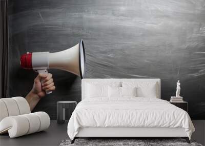 Hand with a megaphone in front of an empty blackboard
 Wall mural