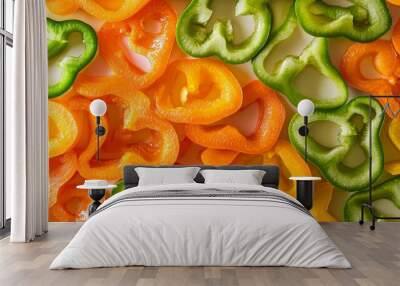 Fresh orange and green bell peppers sliced on a surface, creating a colorful background perfect for food designs. Vibrant and appetizing, conveying freshness and healthiness Wall mural