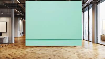 Minimalist light green background featuring a blank horizontal paper sheet, providing ample copy space for text or design elements Wall mural