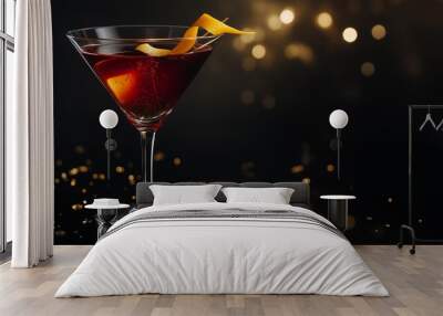 Red cocktail is sparkling in a martini glass, garnished with an orange peel, on a dark background with golden confetti and bokeh. The image evokes a festive and celebratory atmosphere Wall mural