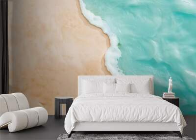 Turquoise ocean water with white foam is meeting golden sand on sunny summer day. Perfect background for summer vacation and travel concept Wall mural