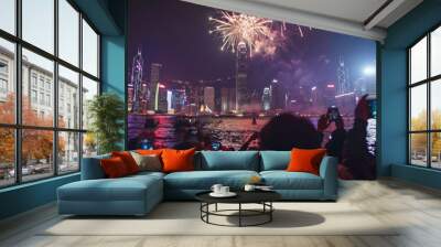 Imagine a New Year's Eve fireworks display over a famous city skyline. The sky is filled with dazzling colors and patterns as fireworks explode above iconic landmarks. Wall mural