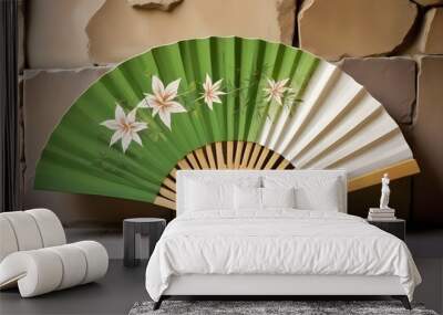 A green and white folding fan with a bamboo frame and a tassel Wall mural