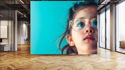 a girl with glasses on light blue background, space for text Wall mural