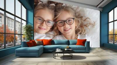 close-up photography of two sisters about 8 years old happy with glasses, white background Wall mural