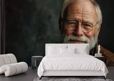 Portrait of a senior man with gray beard and glasses. Studio shot. Wall mural