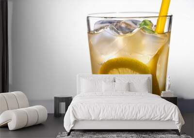 a tall glass of a refreshing lemon drink with ice cubes and a yellow straw Wall mural