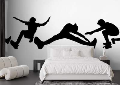 Happy and free young boys dancing silhouettes Wall mural