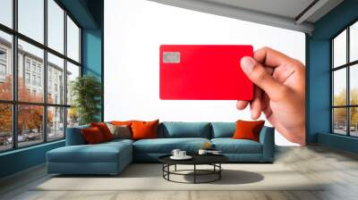 Hand holding a red credit card, white background Wall mural