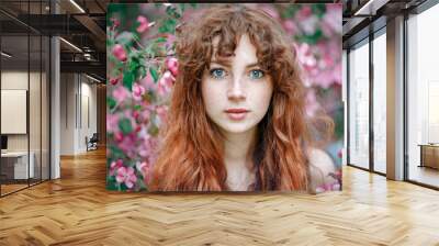 Summer portrait of young tender girl, ginder hair, redhead young girl with freckled skin. Caucasian girl posing in flowers Wall mural