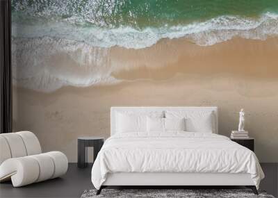 Aerial shot of ocean waves on a sandy beach in Portugal. Wall mural