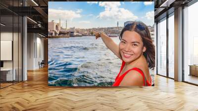 Beautiful woman shows Galata Bridge in Istanbul Wall mural