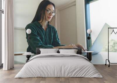 Side view of business woman working from home with laptop Wall mural