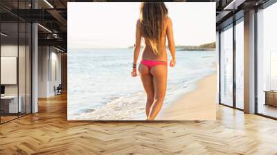 beautiful woman walking on the beach Wall mural