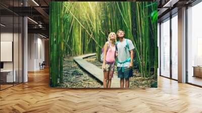 Couple hiking through bamboo forest Wall mural