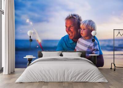 Father and son lighting fireworks Wall mural