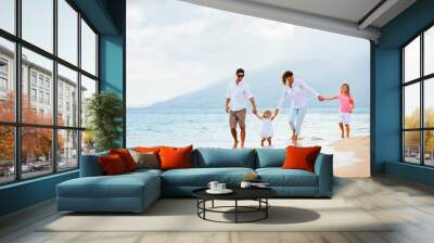 Happy young family walking on the beach Wall mural