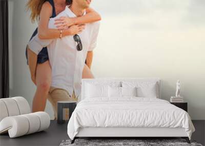 Romantic happy couple on the beach at sunset, man and woman in l Wall mural