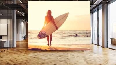 Surfer girl on the beach at sunset Wall mural