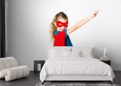 beautiful girl with red mask and supergirl outfit posing in front of white background Wall mural