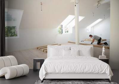 middle-aged man with gray hair glued, laying parquet floor in my loft apartment, top floor Wall mural