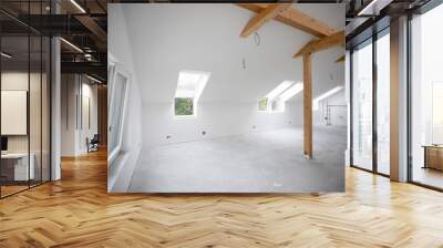 modern attic construction site freshly painted, the floor is still screed, walls are white Wall mural