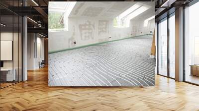 Shot of construction site in a loft where underfloor heating has just been installed, white pipes on grey mat Wall mural