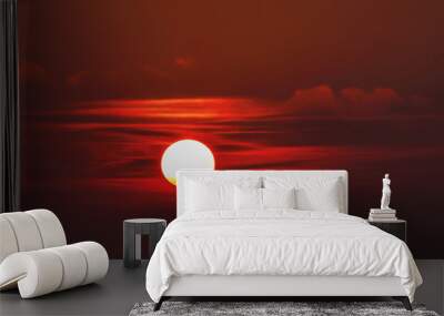 The sun towards the sunset in the clouds spreads red light Wall mural