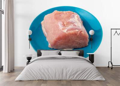 A piece of meat on a white background. Raw piece of pork on a plate close-up. Wall mural