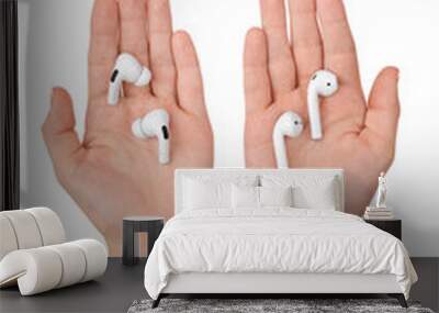 Wireless headphones in a hands on a white background. Wall mural