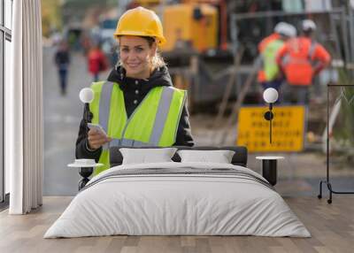 female construction woman using electronics on construction site Wall mural