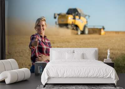 happy female farmer in wheat field Wall mural