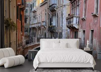 Beautiful bridge over a small canal lined, on colorful building background, Venice, Italy, during Lockdown Crisis COVID-19 Wall mural