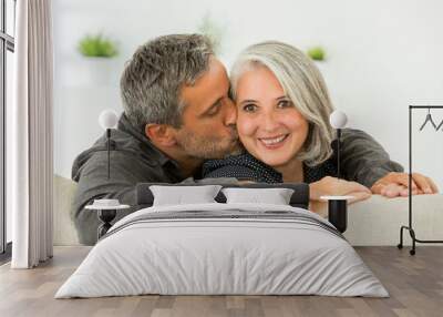 middle aged couple on a sofa: in love concept Wall mural