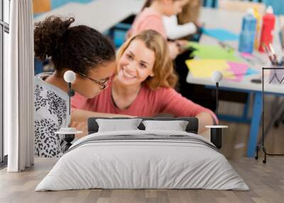 teacher helping schoolgirl at school Wall mural