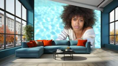 young african american black woman relaxing by the pool and lying on the deck. Wall mural