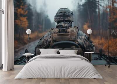 POV from behind a soldier in combat gear driving a tank Wall mural