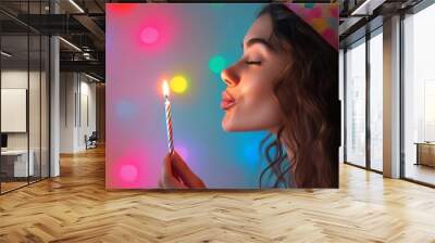 woman blowing out the birthday candle Wall mural