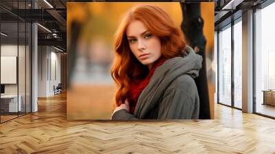 A portrait of a woman with red hair and a grey coat in an autumn setting. Wall mural