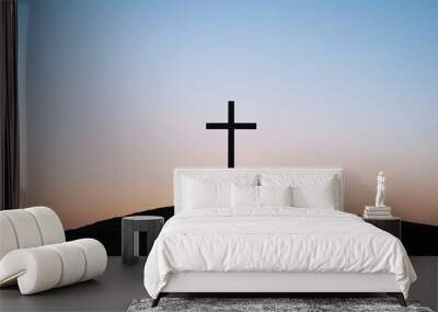 A cross standing tall on a hill at sunrise, symbolizing hope and resurrection. Wall mural