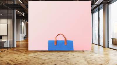 A blue and pink bag with a brown strap Wall mural