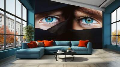 A woman with blue eyes is wearing a black scarf Wall mural