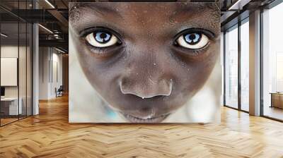 A young boy with brown skin and blue eyes Wall mural